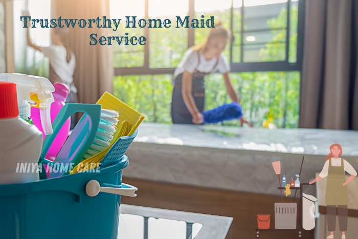 Close-up of a cleaning supplies bucket with a professional maid cleaning a room in the background, showcasing the trustworthy home maid services provided by Iniya Home Care in Pollachi. Ensuring meticulous and reliable housekeeping for your home