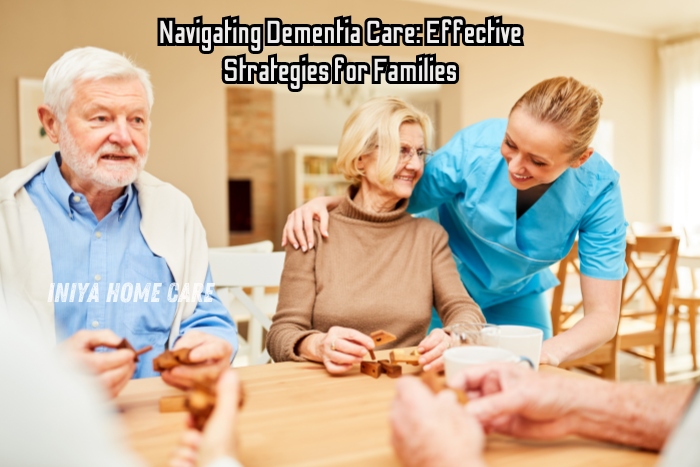 Navigating dementia care with Iniya Home Care in Pollachi. A caregiver smiles and supports elderly clients during an activity, symbolizing compassionate dementia care. This image highlights effective strategies for families managing dementia, emphasizing personalized care and emotional support