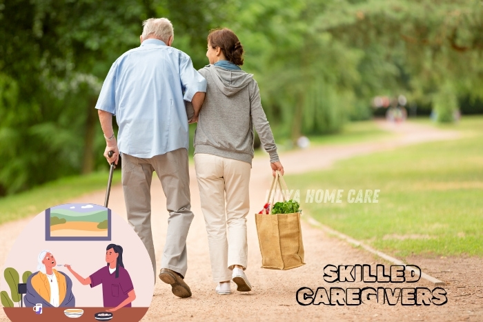 Skilled caregivers from Iniya Home Care assisting an elderly man while walking in a park in Pollachi.