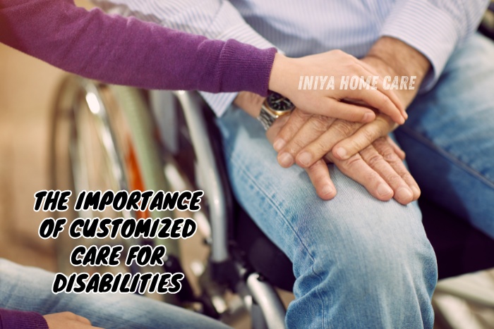 Caregiver's hand supporting the hands of a person in a wheelchair, symbolizing dedicated personalized assistance by Iniya Home Care