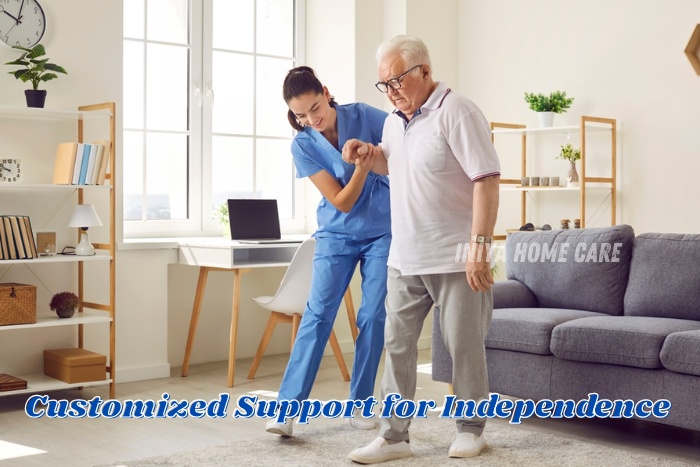 Professional caregiver from INIYA HOME CARE in Pollachi helping an elderly man walk confidently at home