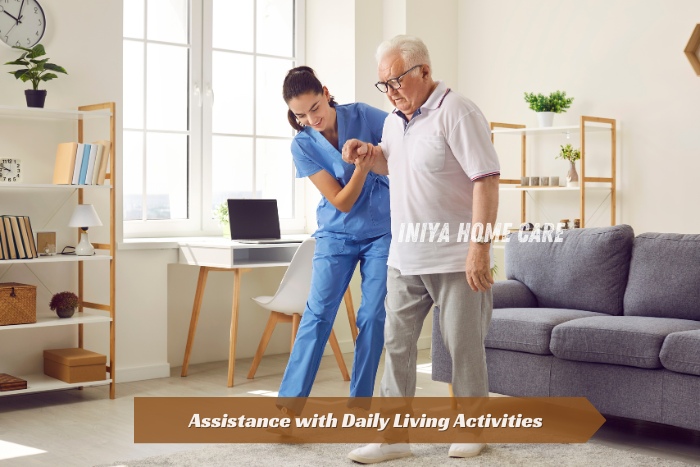 Trained caregiver from Iniya Home Care in Pollachi assisting an elderly man with walking support at home